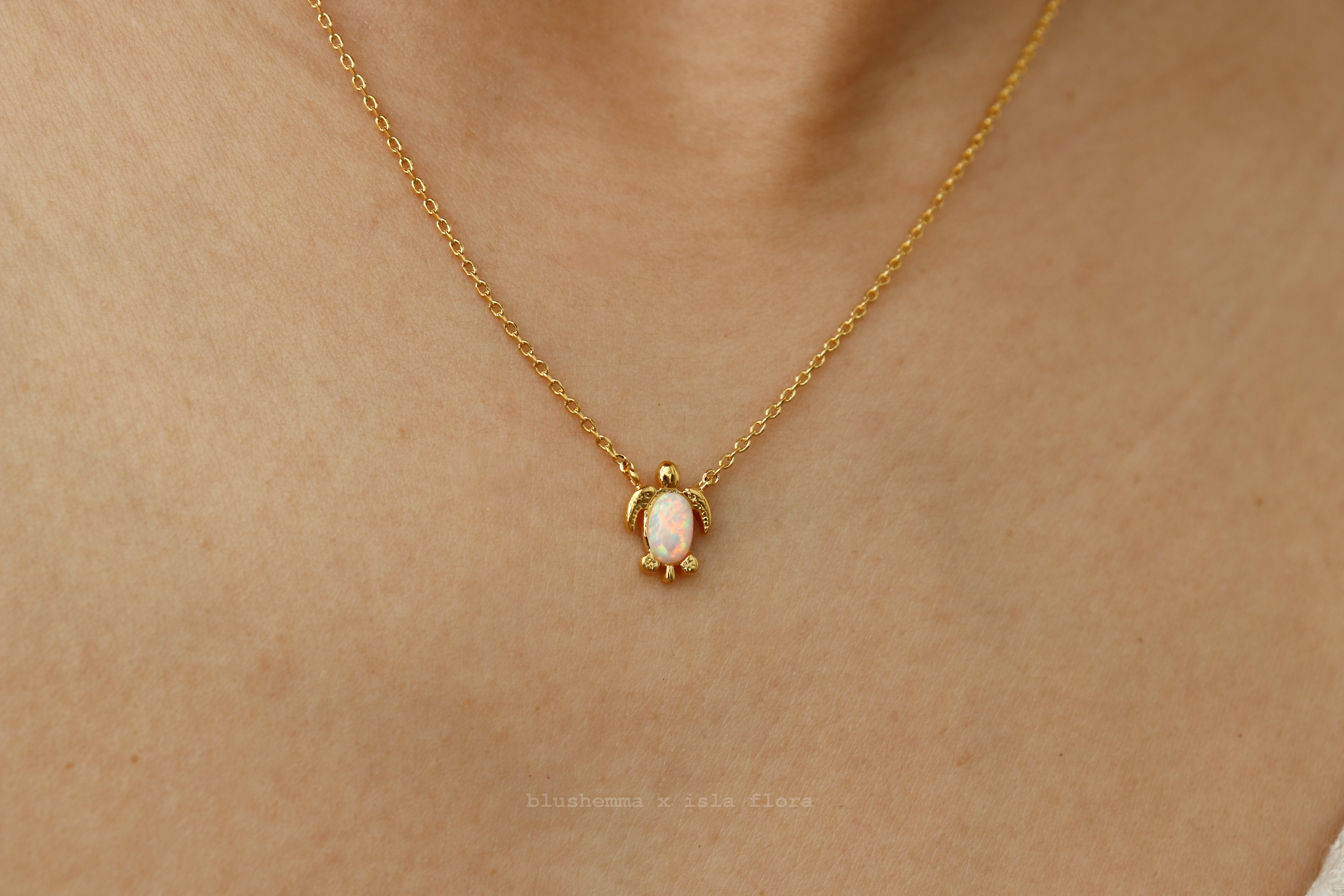 The Opal Sea Turtle Charm Necklace by isla flora Gold necklace with a turtle pendant on a person's neck