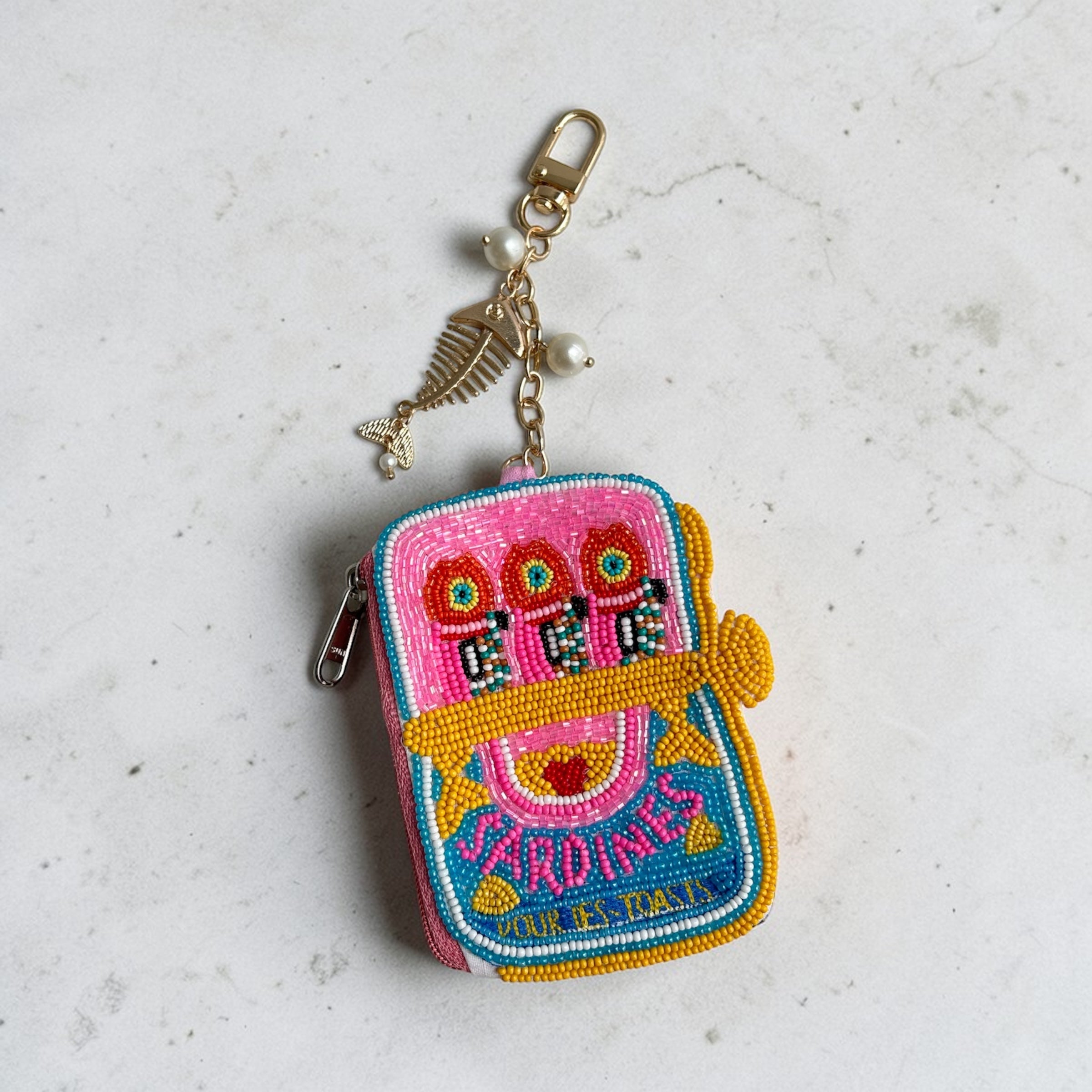 Hot Pink beaded Sardine Pouch Colorful embroidered keychain on a light gray background