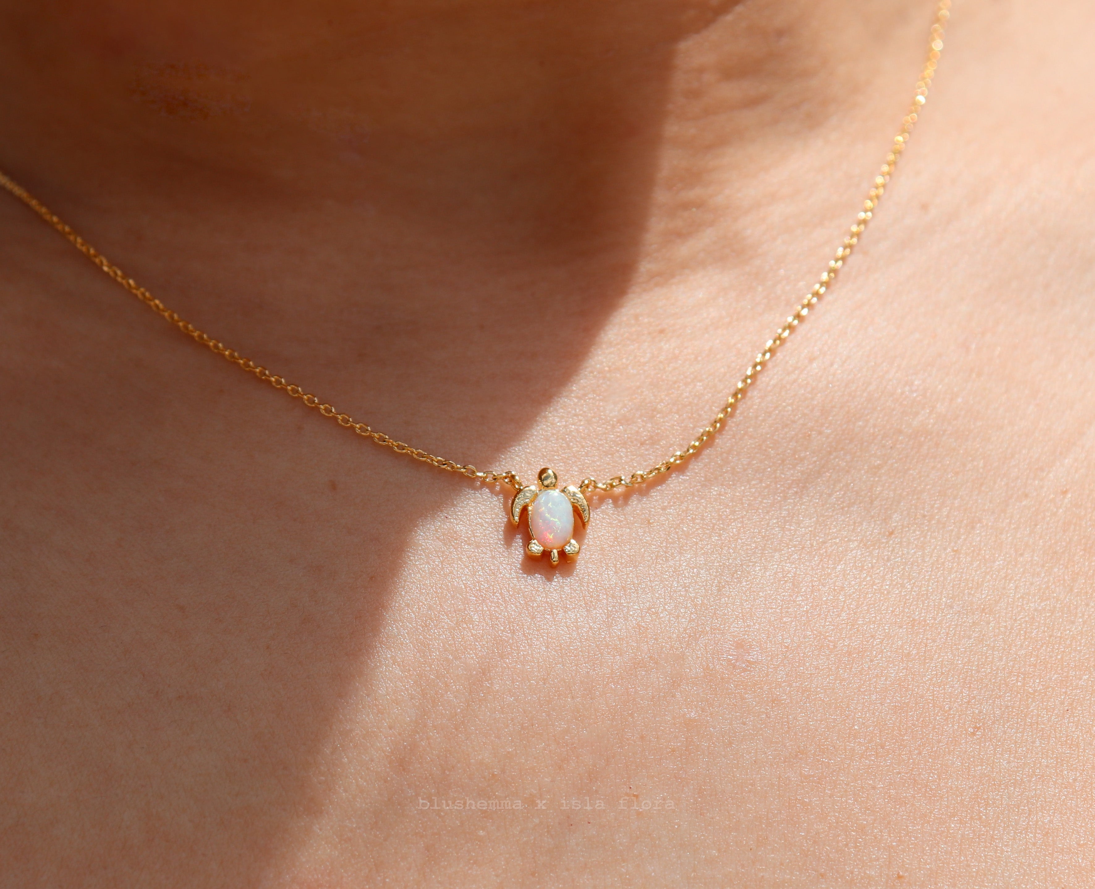 The Opal Sea Turtle Charm Necklace by isla flora Gold necklace with a small pendant on a person's neck