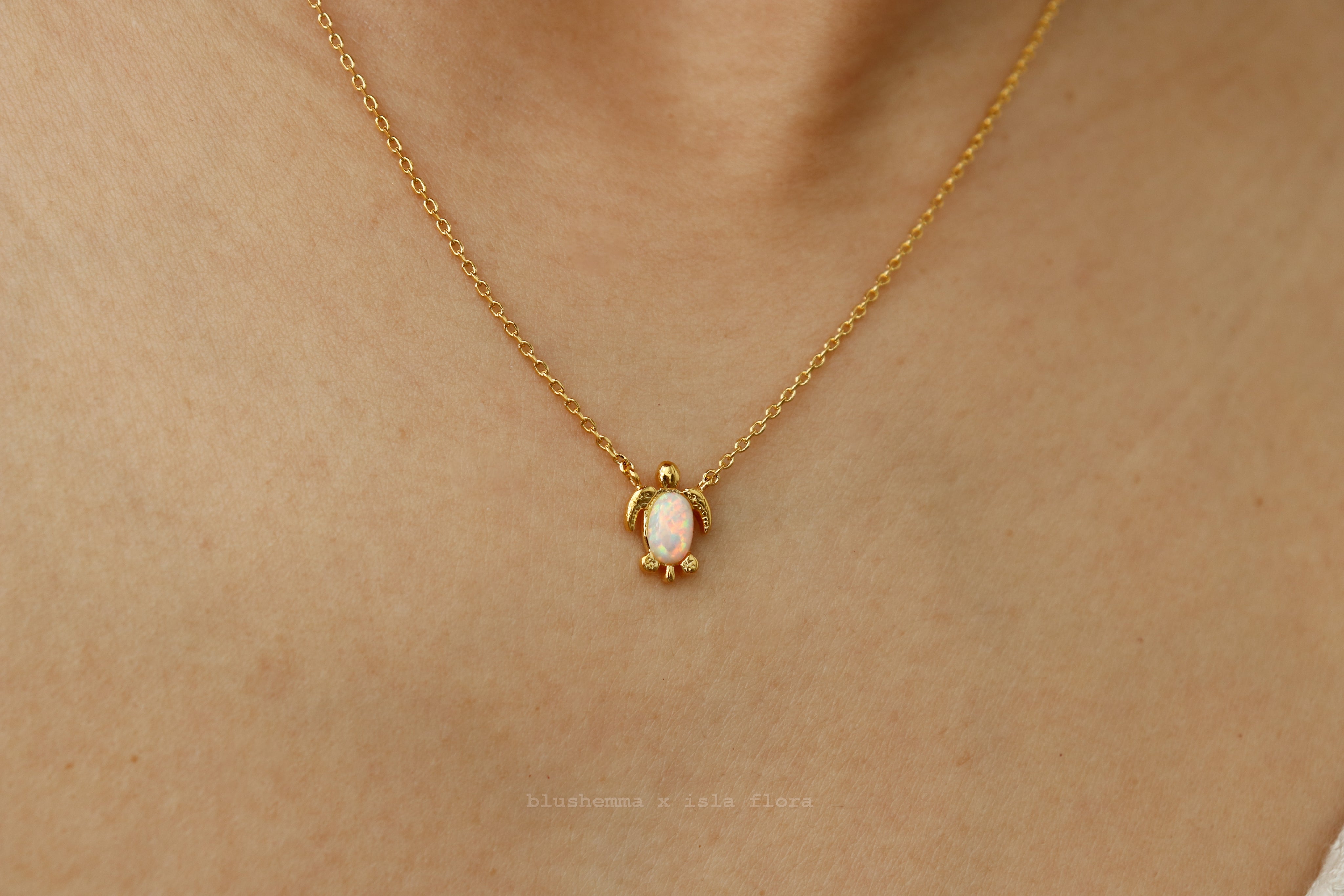 The Opal Sea Turtle Charm Necklace by isla flora Gold necklace with a turtle pendant on a person's neck
