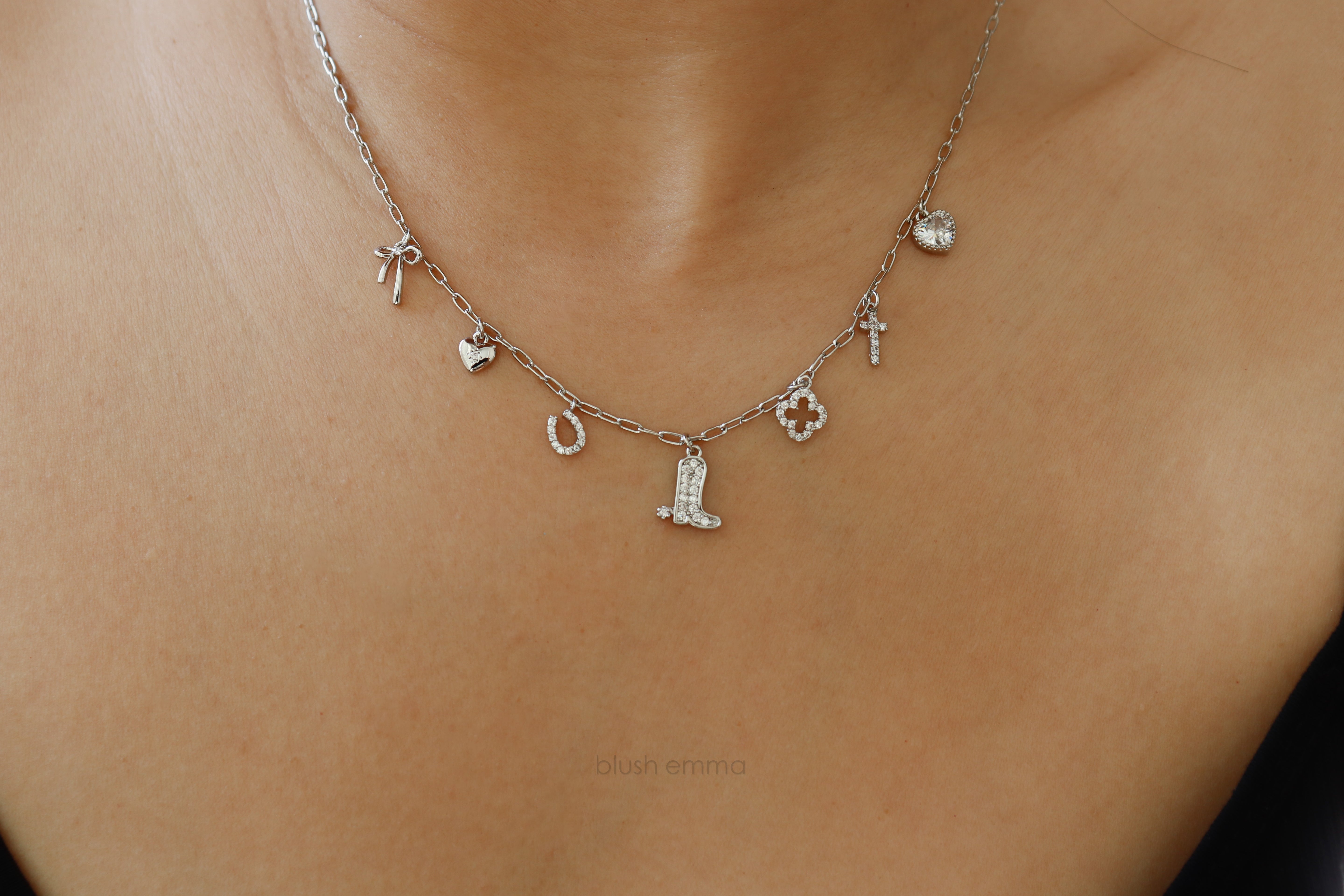 Dainty Small Sparkly Charms Station Necklace. Charms are placed on tiny paperclip chain, charms include: Ribbon, Micro Heart, Horseshoe, Boots, Clover, Cross and Crystal Heart