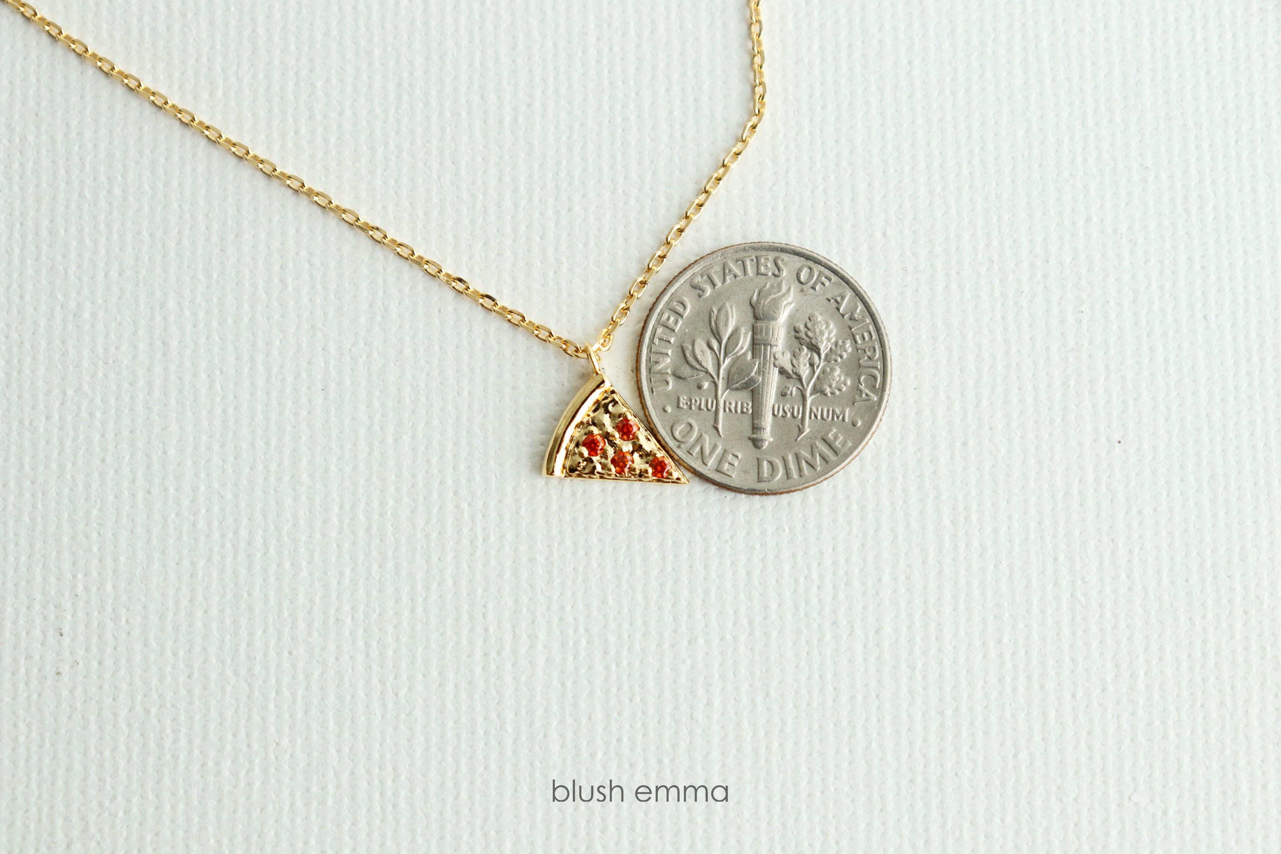 Dainty Red Cubic Pepperoni Pizza Pendant Necklace. Cute Pizza slice for layering, perfect foodie gift. Gold necklace with a pizza-shaped pendant on a light background
