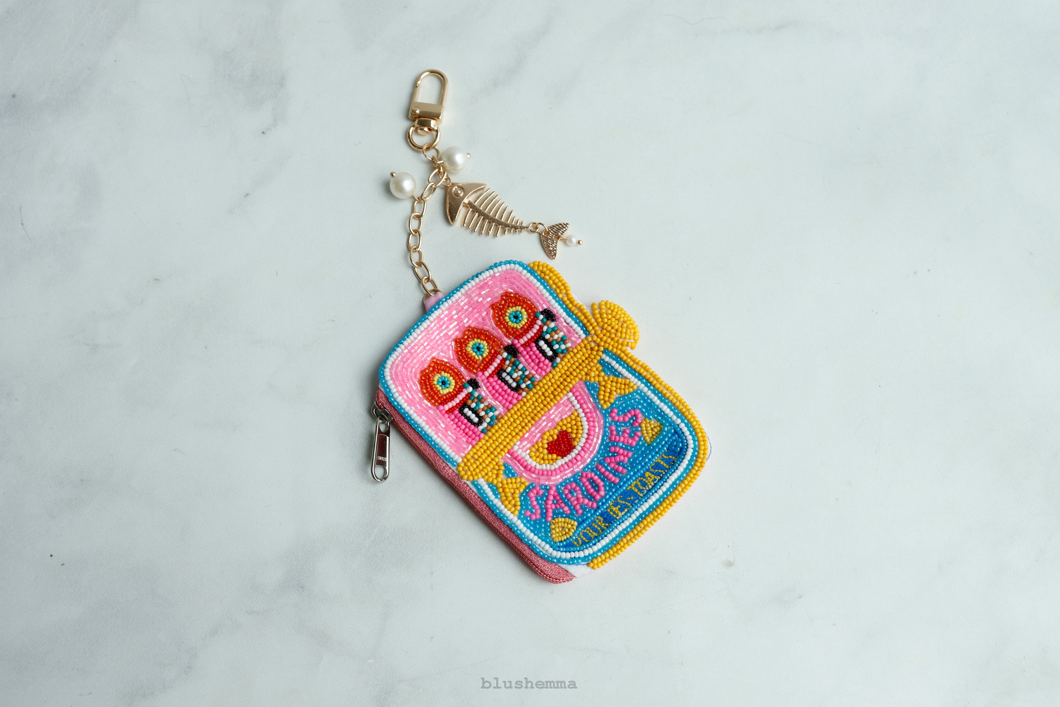 Hot Pink beaded Sardine Pouch Colorful embroidered keychain on a light gray background