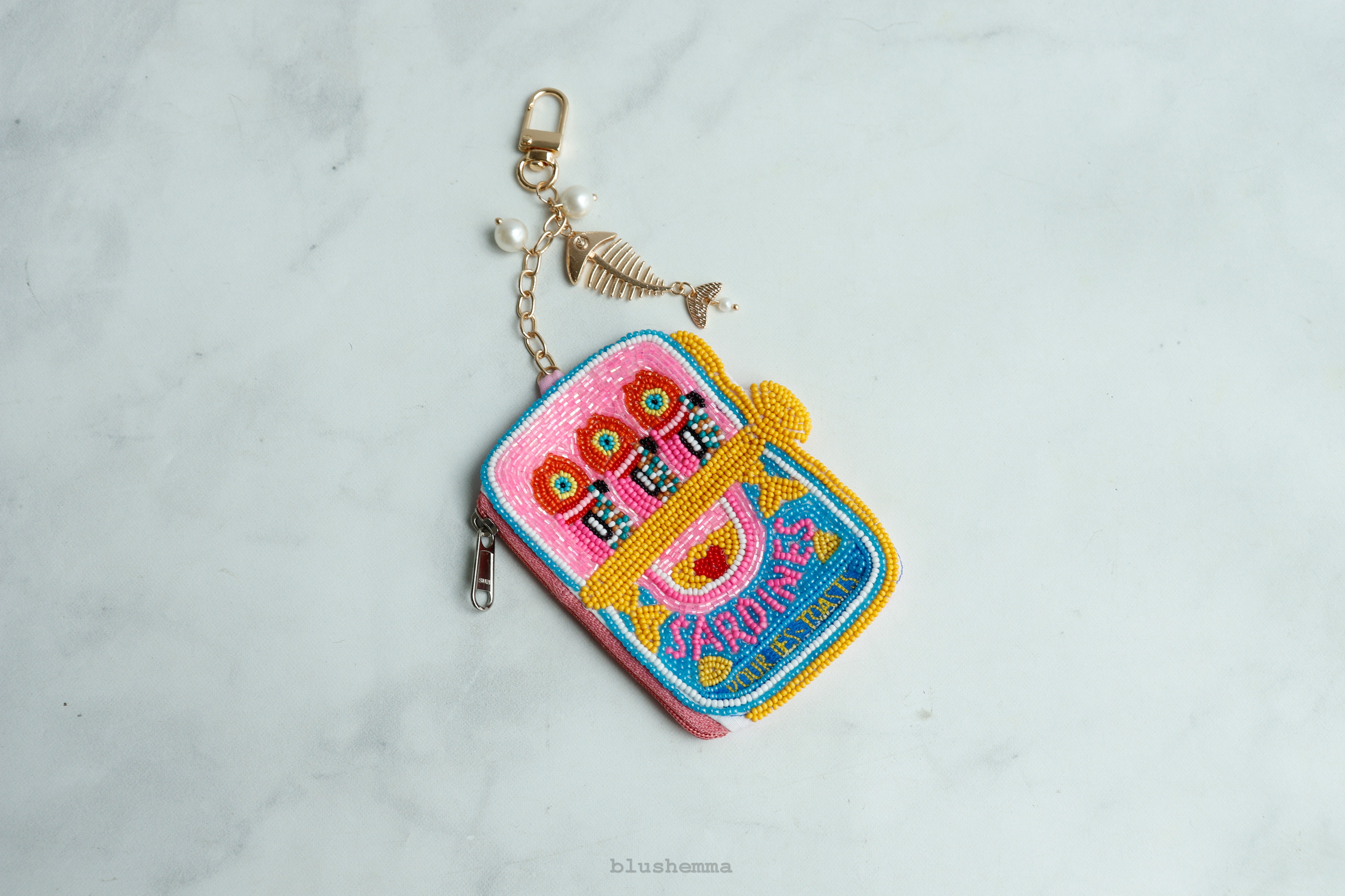 Hot Pink beaded Sardine Pouch Colorful embroidered keychain on a light gray background
