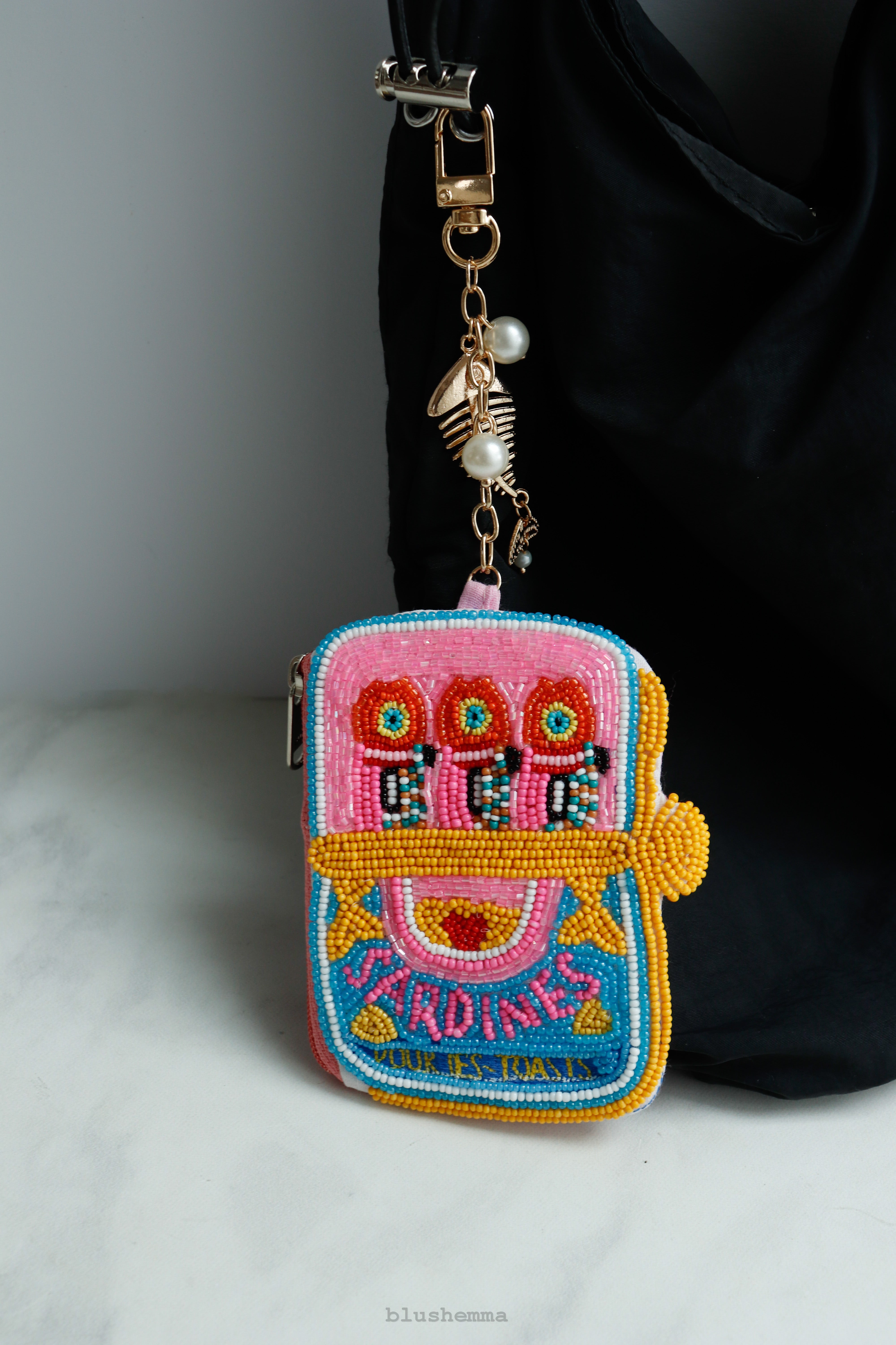 Mini Beaded Sardine Can Pouch Keychain, Colorful, embroidered Coinbag on a light gray background