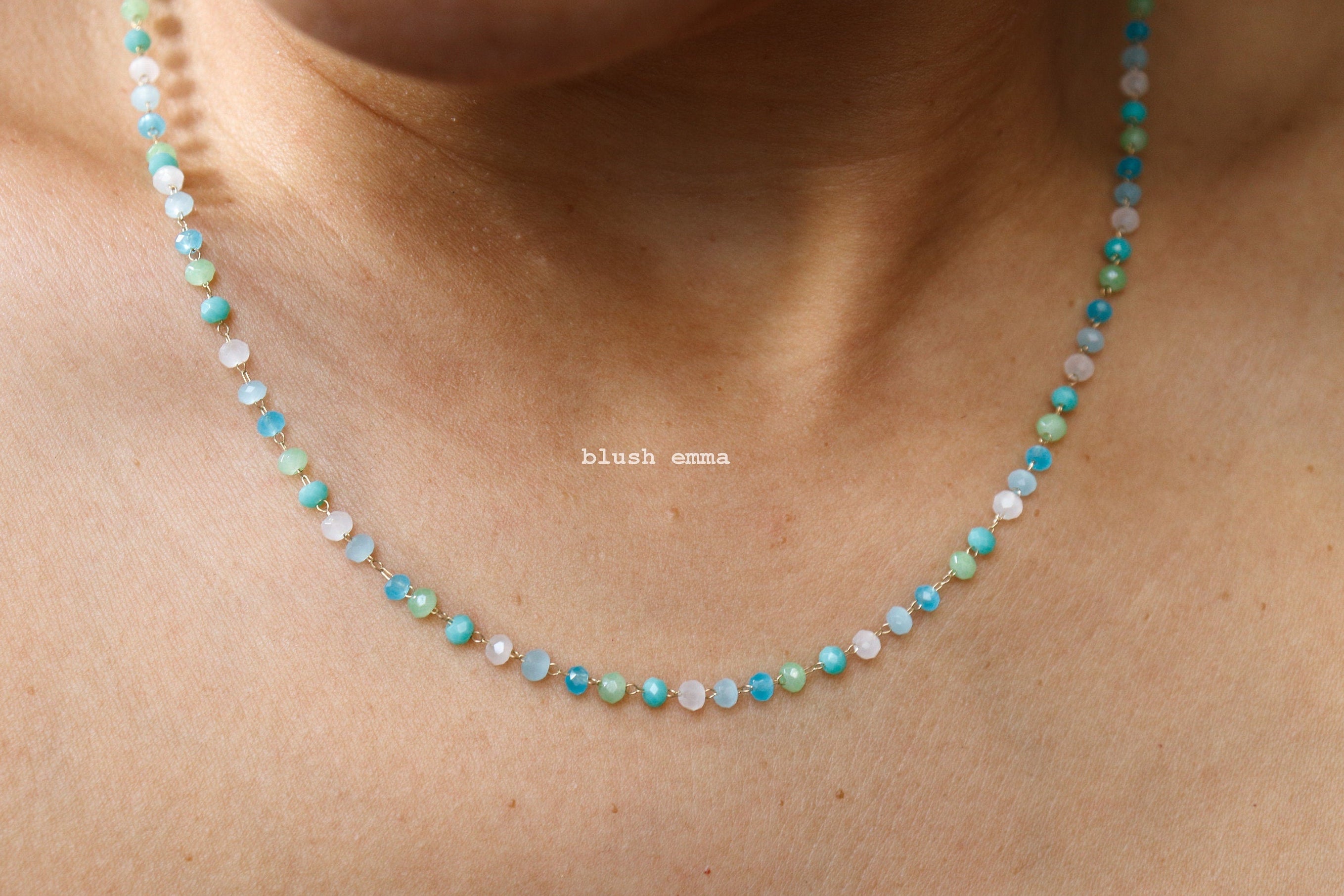 bright blue mint Necklace with small beads on a person's neck, brand 'blush mama' visible.