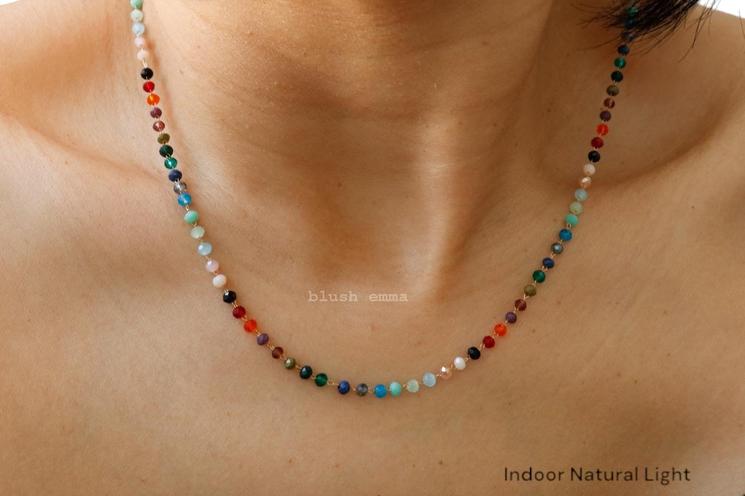 Colorful beaded necklace on a person's neck with 'Indoor Natural Light' text.