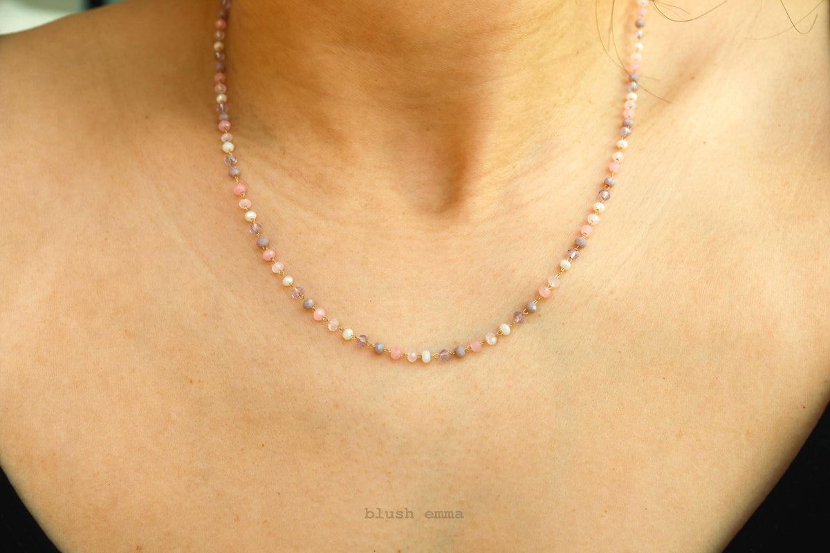 Necklace with small beads on a person's neck, brand 'blush' visible